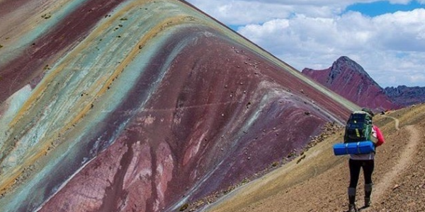 A Traveler Walking On The Rainbow Mountains.