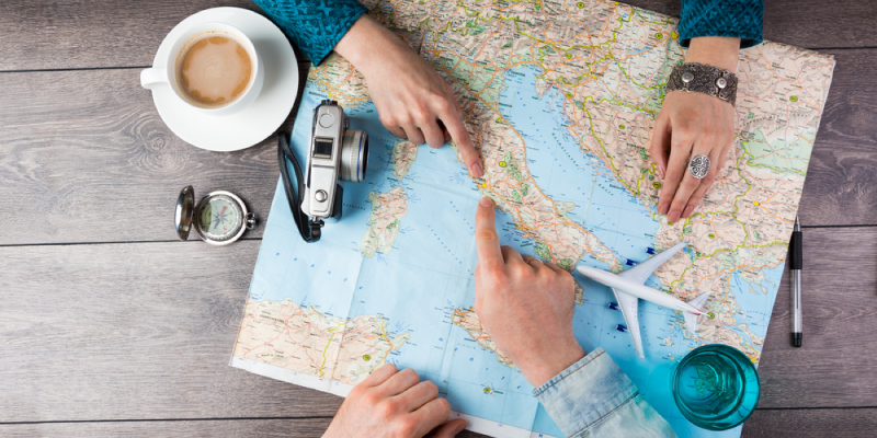 Two People Planning Their Travel With The Help of Map
